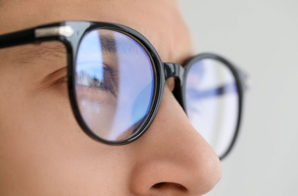 Close-up profile of a person wearing black-rimmed eyeglasses.